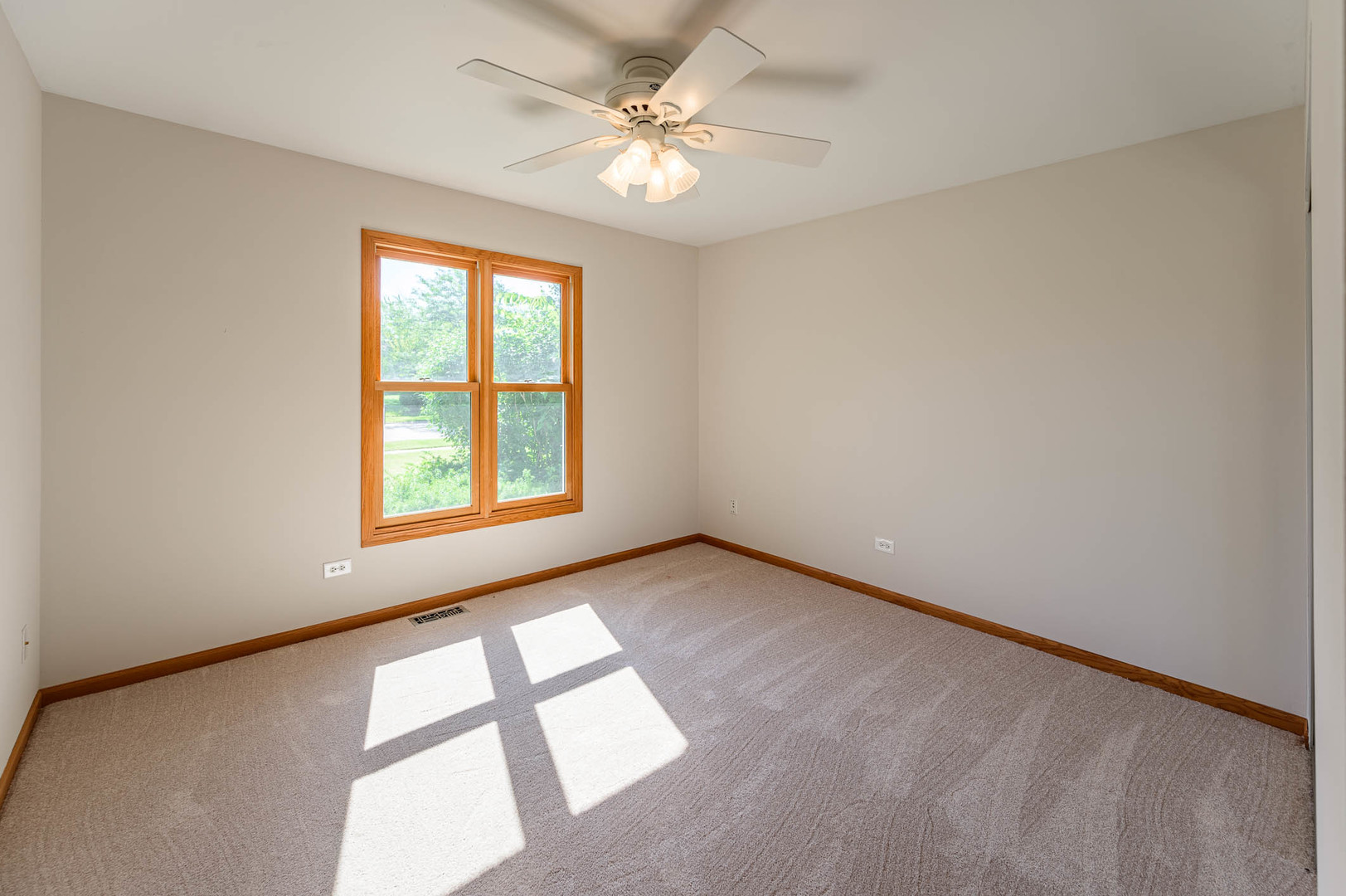 638 Colony Avenue Lindenhurst, IL 60046 - Photo 7 of 15 an empty room with windows and ceiling fan view