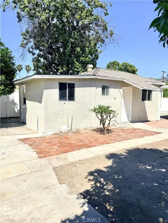 a front view of a house with a yard and a garage