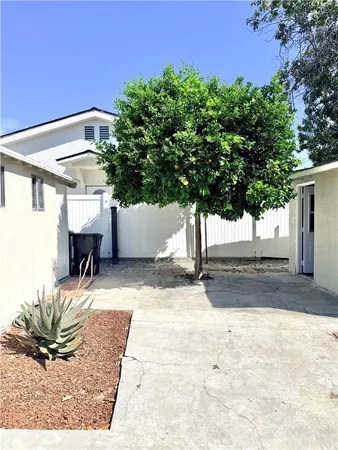 a view of backyard with a patio and a garden