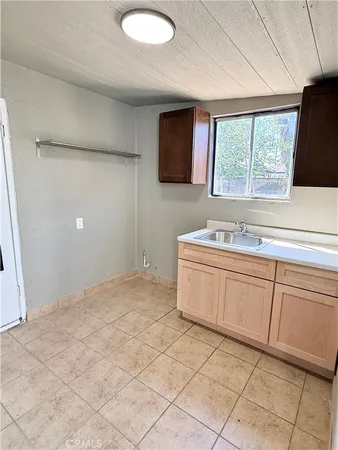a view of a livingroom with an empty space and a window