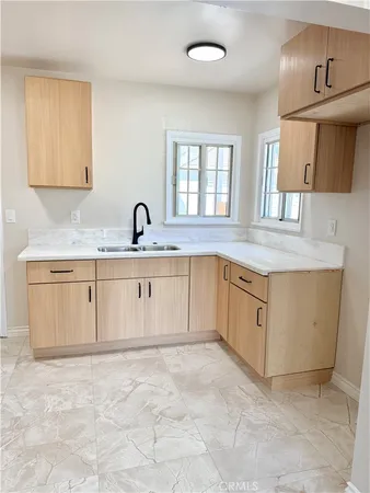 a kitchen with granite countertop a sink and cabinets