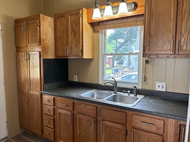 404 South Hall Street Morrison, IL 61270 - Photo 11 of 25 a kitchen with stainless steel appliances granite countertop a sink a refrigerator and cabinets