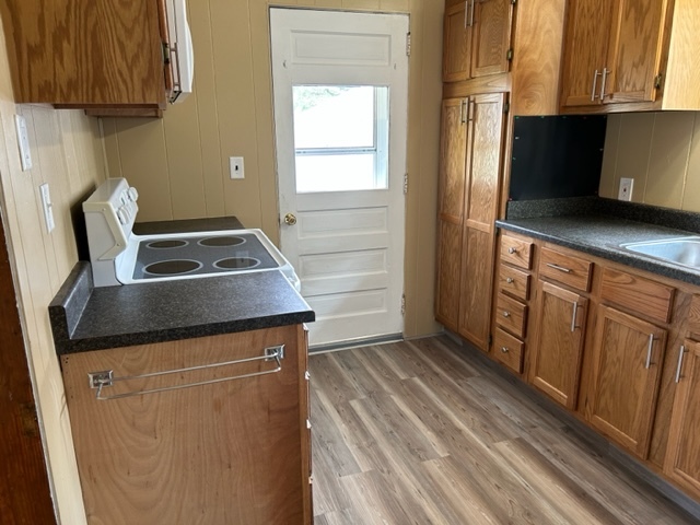 404 South Hall Street Morrison, IL 61270 - Photo 12 of 25 a kitchen with wooden cabinets and a stove top oven