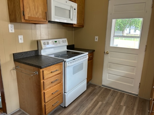 404 South Hall Street Morrison, IL 61270 - Photo 13 of 25 a kitchen with granite countertop white cabinets and white appliances