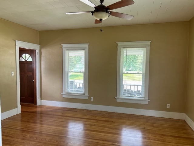 404 South Hall Street Morrison, IL 61270 - Photo 16 of 25 an empty room with wooden floor windows and fan