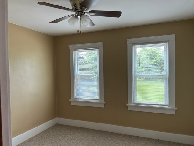 404 South Hall Street Morrison, IL 61270 - Photo 20 of 25 an empty room with a window and a fan