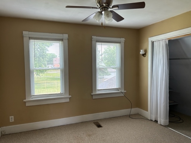 404 South Hall Street Morrison, IL 61270 - Photo 22 of 25 an empty room with a window and a fan