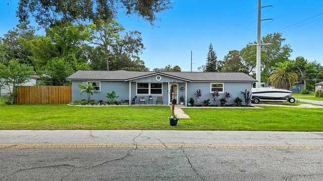 a front view of a house with a garden