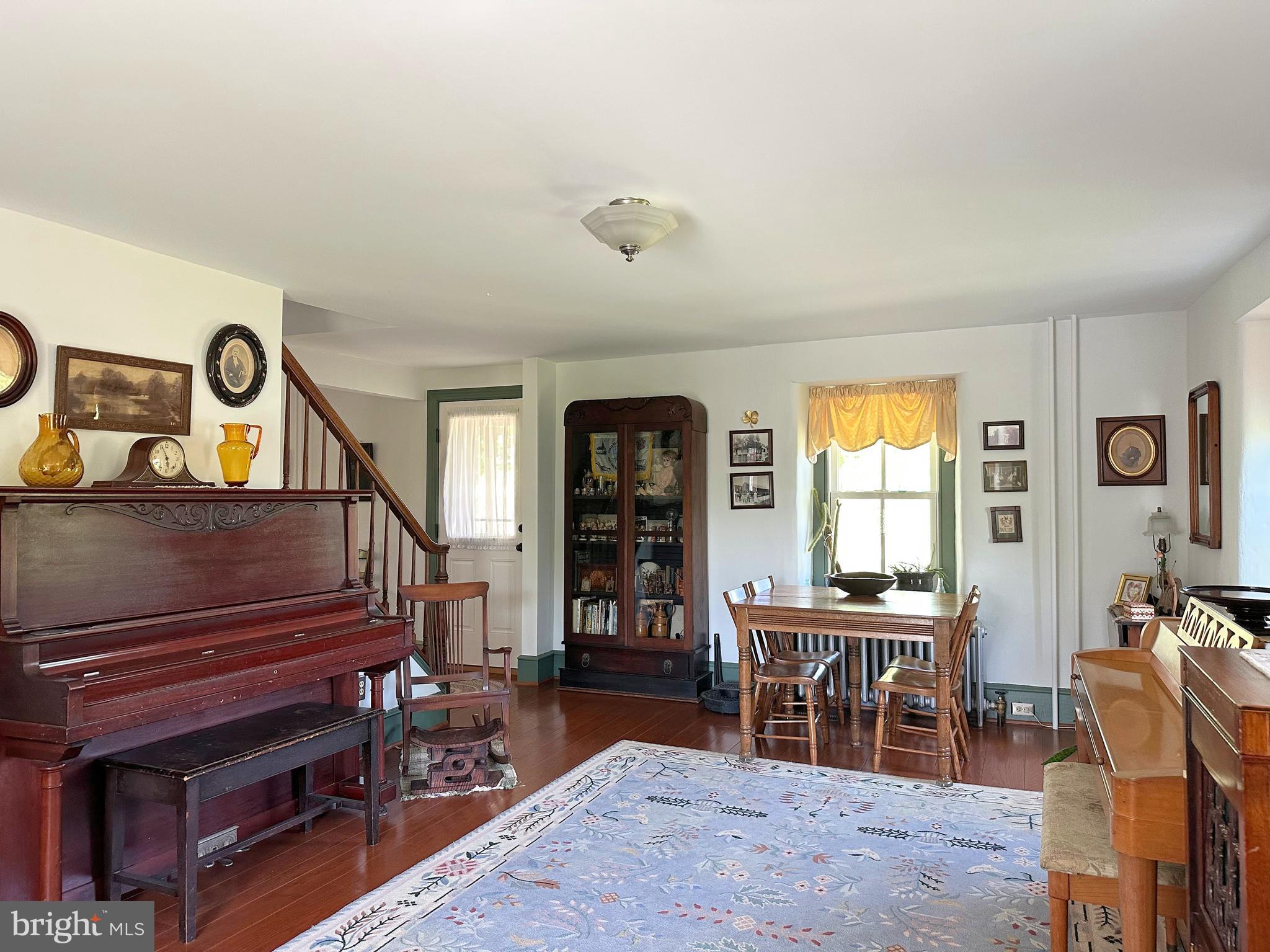 2382 Bergey Road Harleysville, PA 19438 - Photo 29 of 52 a living room with furniture a dining table a lamp and a window