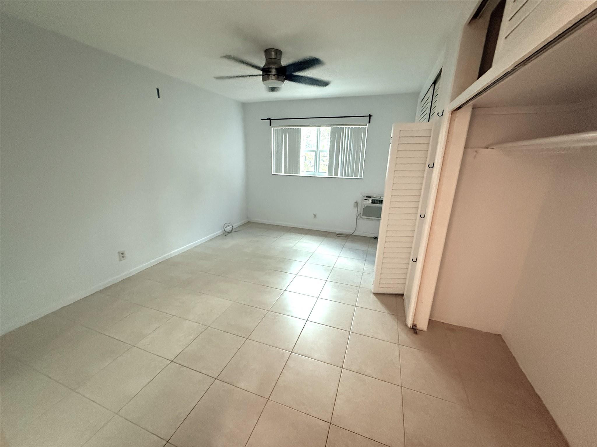 3205 Colony Club Road, Unit 1 Pompano Beach, FL 33062 - Photo 11 of 12 a view of an empty room with a window
