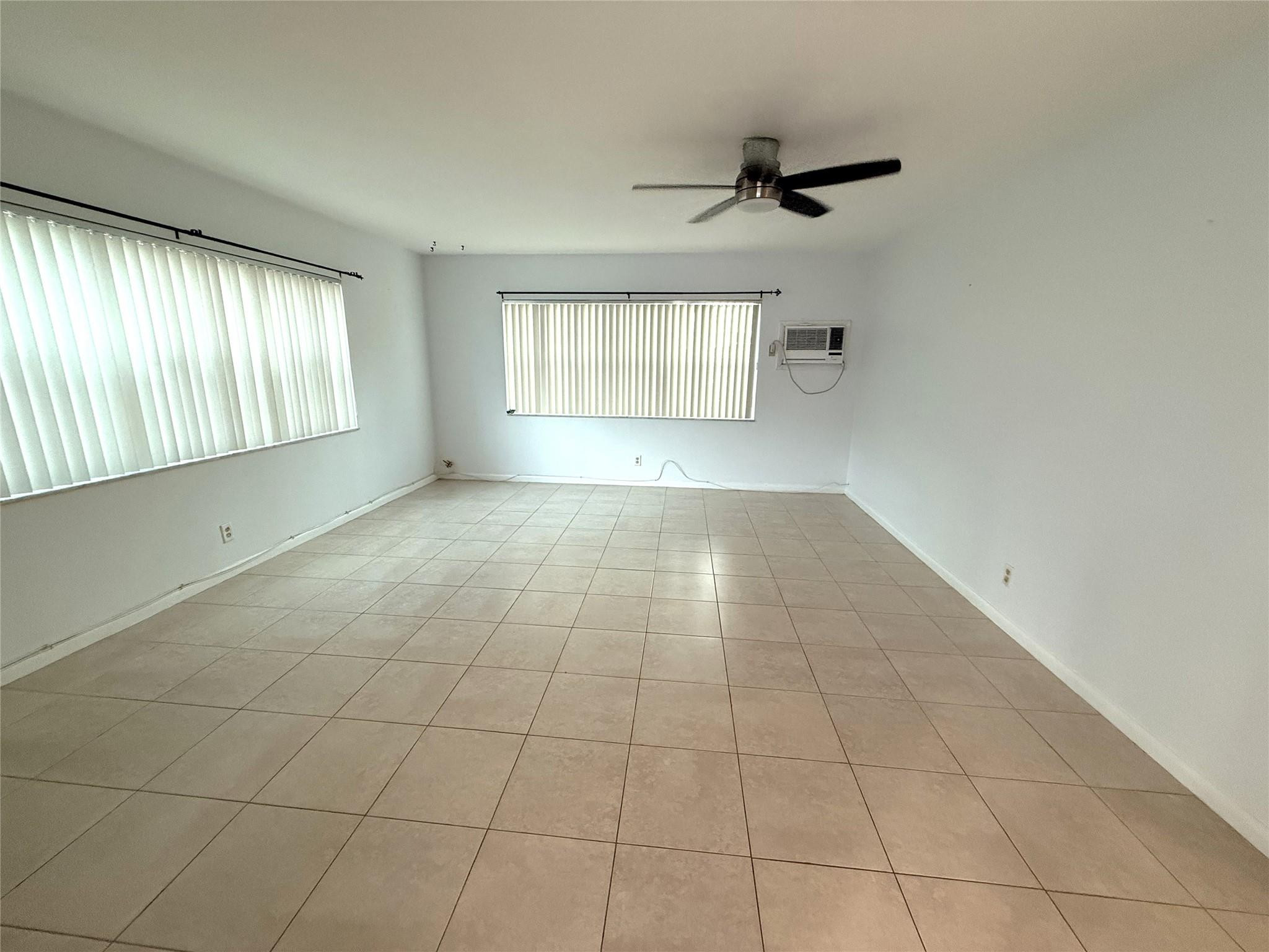3205 Colony Club Road, Unit 1 Pompano Beach, FL 33062 - Photo 8 of 12 a view of an empty room with a window
