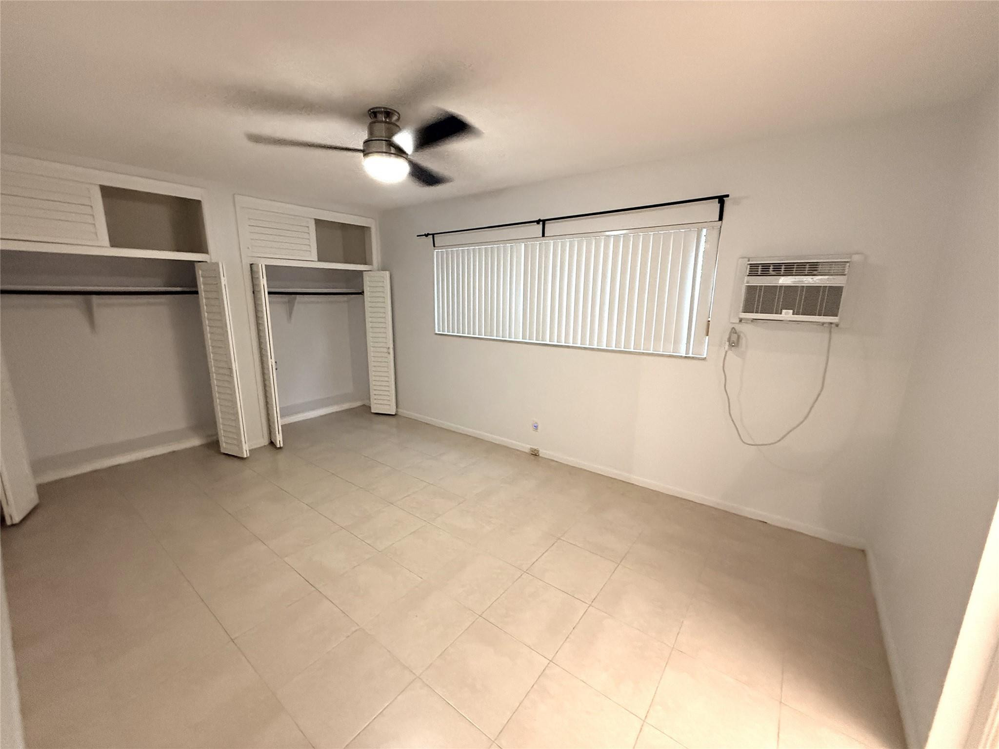 3205 Colony Club Road, Unit 1 Pompano Beach, FL 33062 - Photo 9 of 12 a view of empty room with ceiling fan