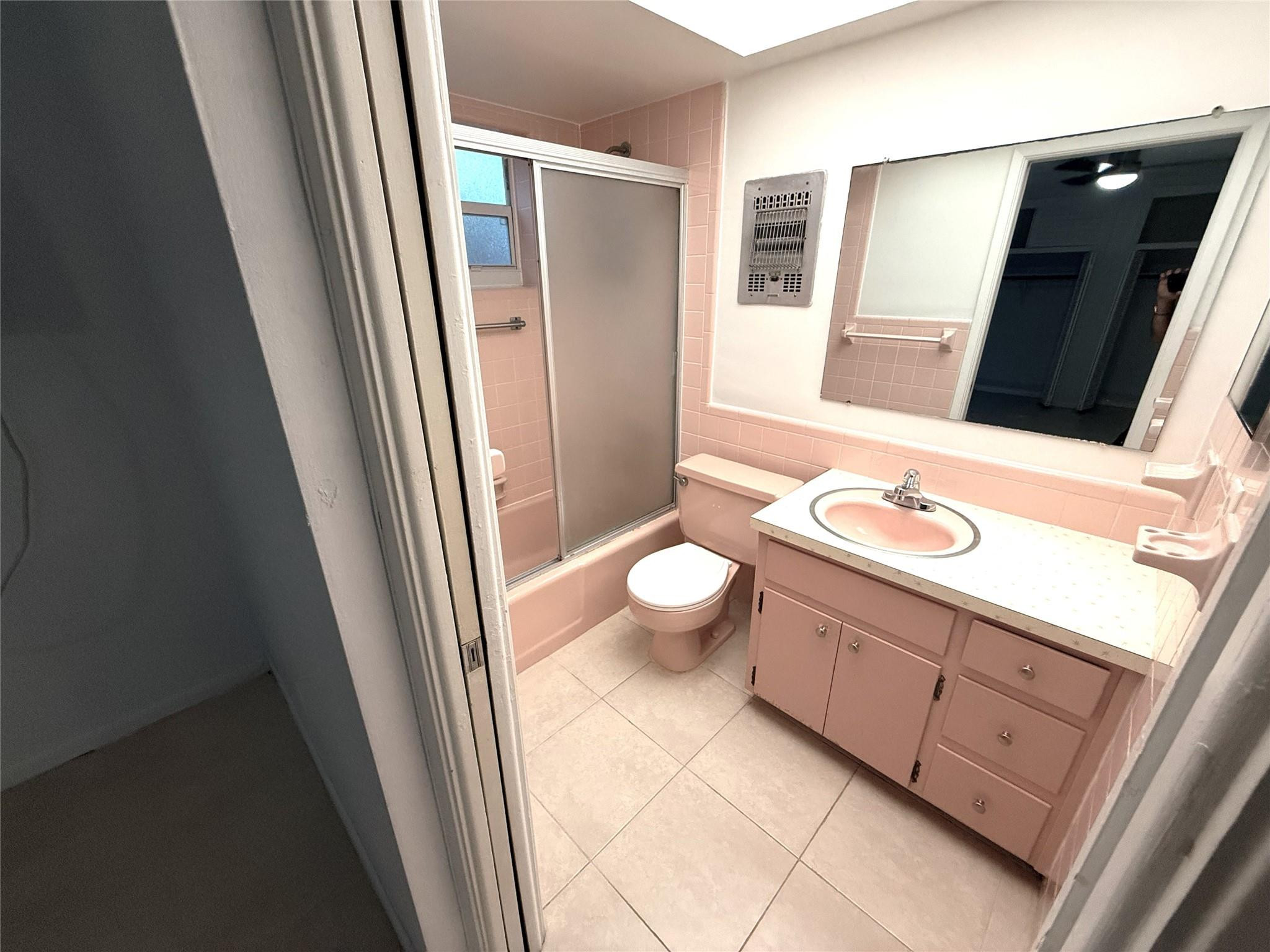 3205 Colony Club Road, Unit 1 Pompano Beach, FL 33062 - Photo 10 of 12 a bathroom with a granite countertop sink toilet and mirror
