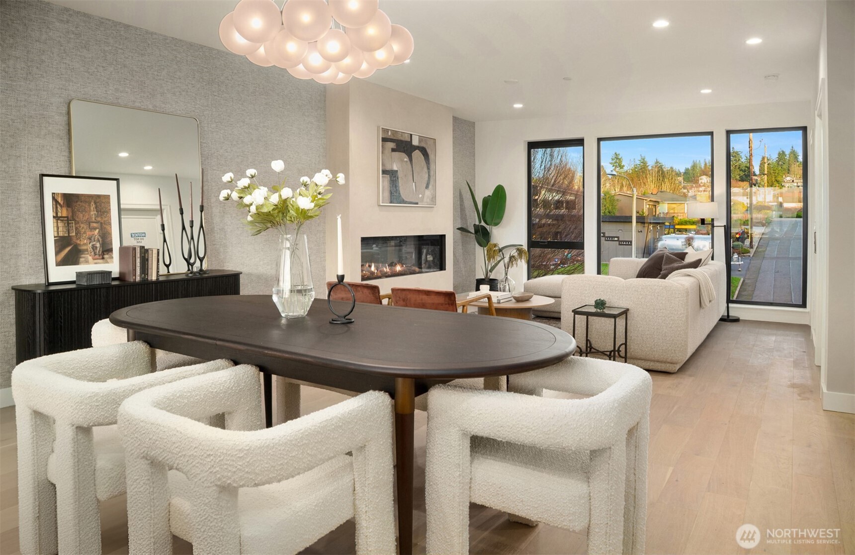 614 5th Avenue South, Unit A103 Edmonds, WA 98020 - Photo 13 of 28 a view of a dining room with furniture a chandelier and large windows