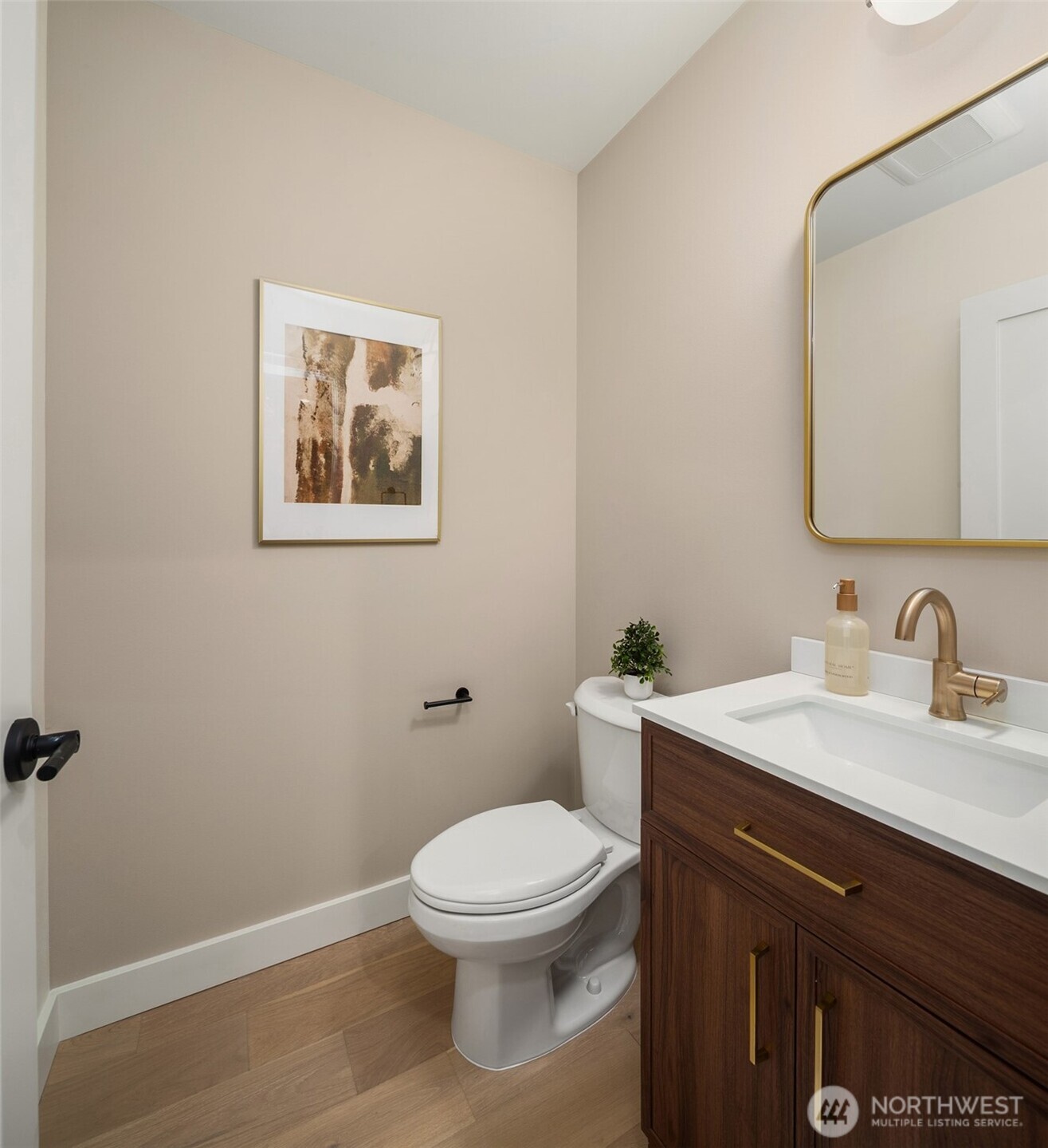 614 5th Avenue South, Unit A103 Edmonds, WA 98020 - Photo 19 of 28 a bathroom with a toilet a sink and mirror