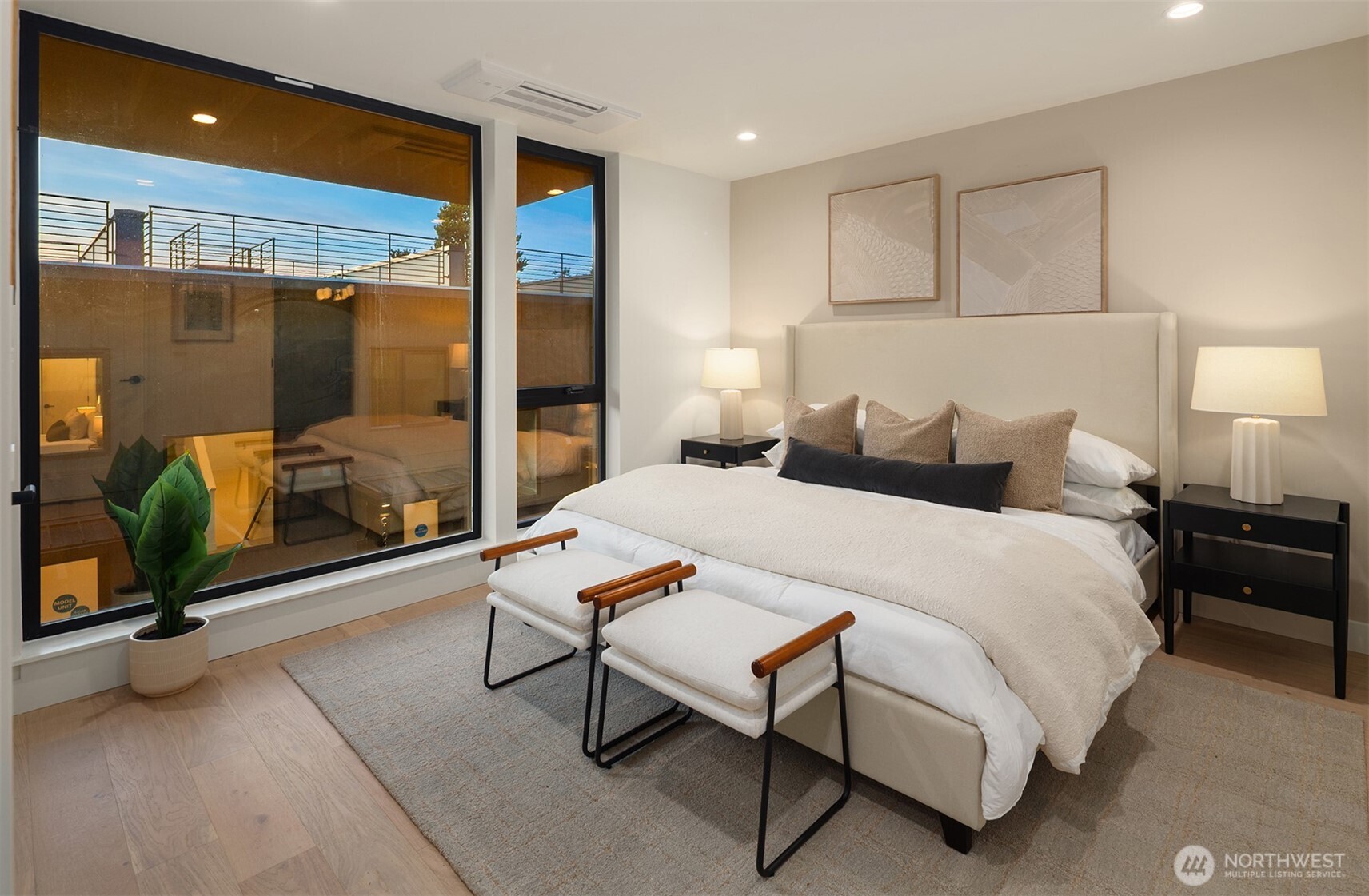 614 5th Avenue South, Unit A103 Edmonds, WA 98020 - Photo 20 of 28 a bedroom with a bed and a chandelier