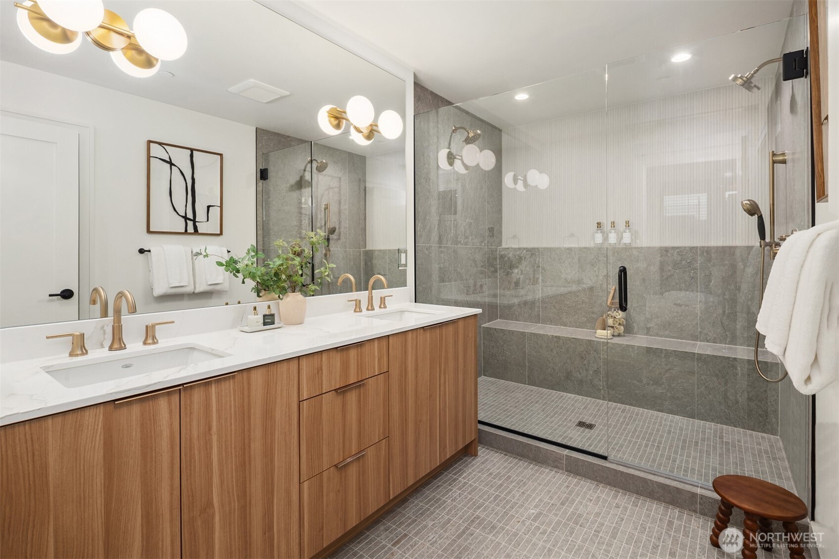 614 5th Avenue South, Unit A103 Edmonds, WA 98020 - Photo 22 of 28 a bathroom with a double vanity sink a mirror and a bathtub