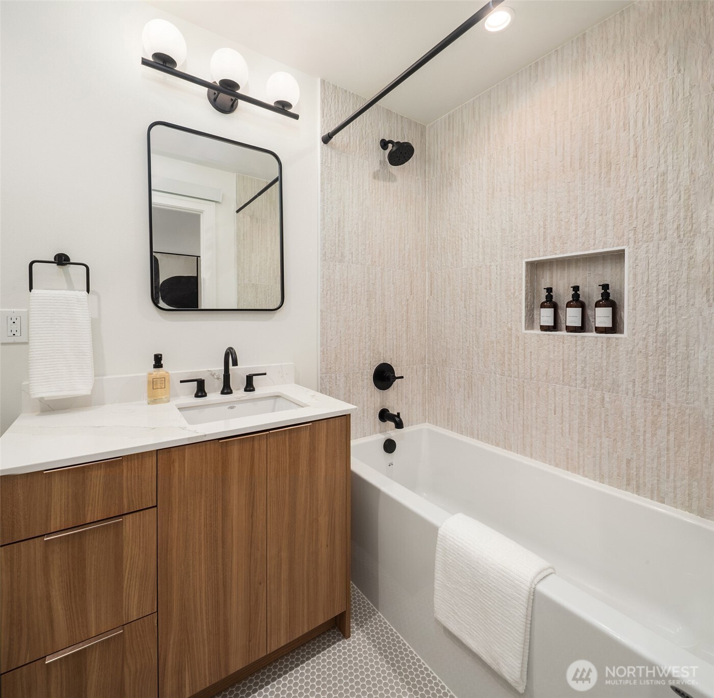 614 5th Avenue South, Unit A103 Edmonds, WA 98020 - Photo 25 of 28 a bathroom with a bathtub a mirror and sink