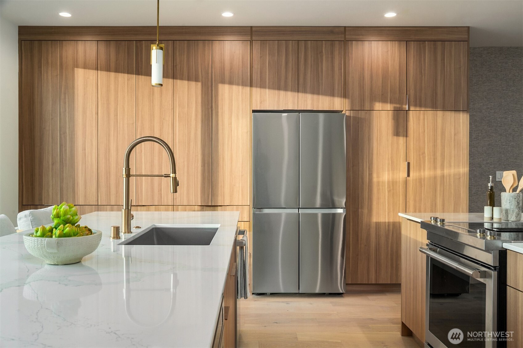 614 5th Avenue South, Unit A103 Edmonds, WA 98020 - Photo 10 of 28 a kitchen with a refrigerator and a table
