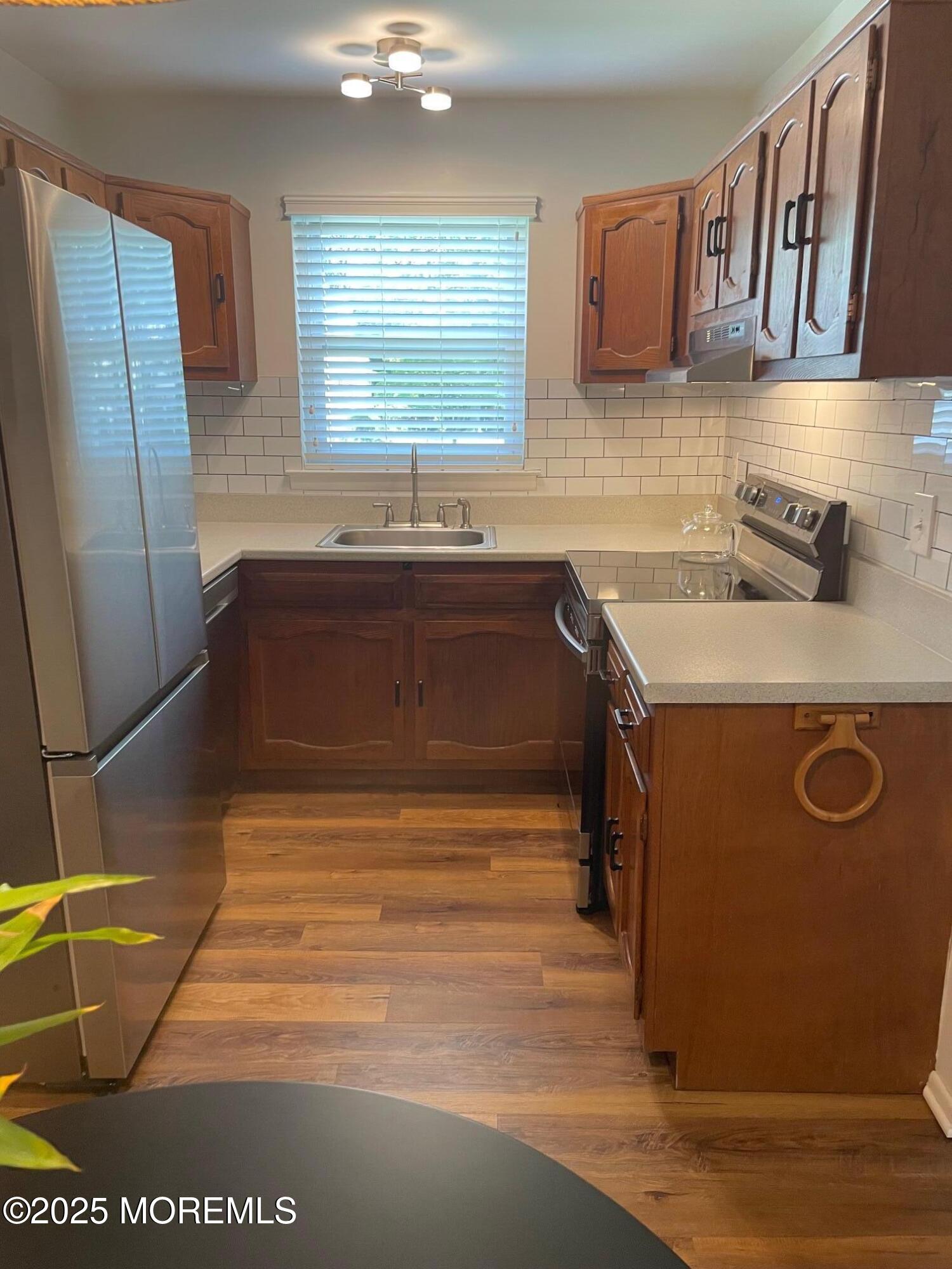 18 Valley Forge Drive, Unit A Whiting, NJ 08759 - Photo 11 of 22 a kitchen with granite countertop a sink a stove and a wooden floor