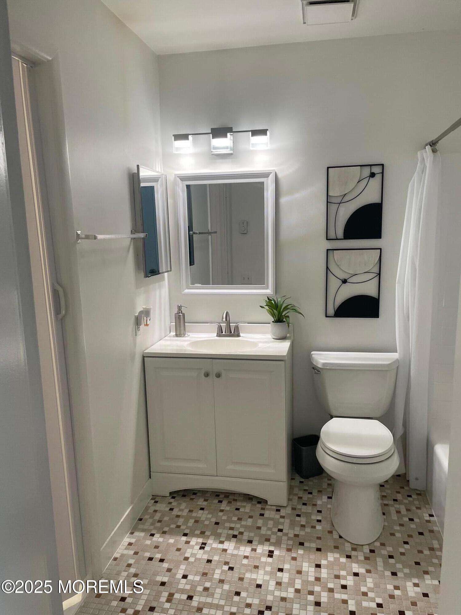 18 Valley Forge Drive, Unit A Whiting, NJ 08759 - Photo 19 of 22 a bathroom with a toilet sink and mirror