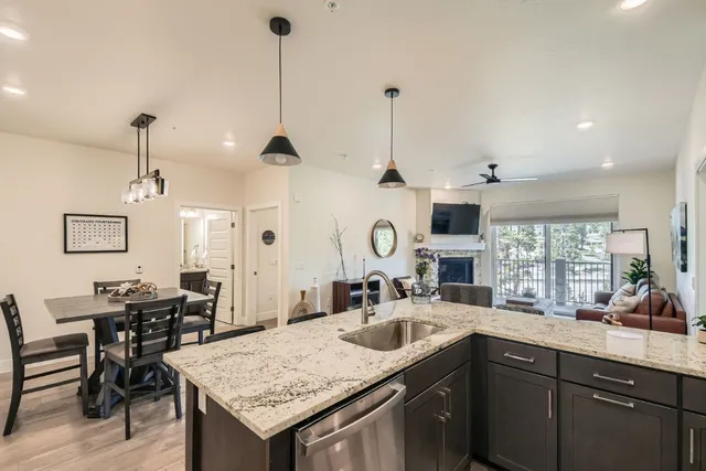 a kitchen with center island table and chairs