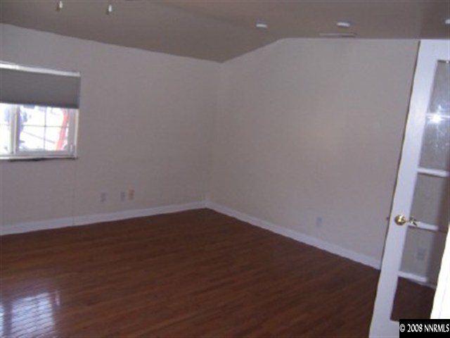 645 Starlight Circle Reno, NV 89509 - Photo 8 of 9 an empty room with wooden floor and windows