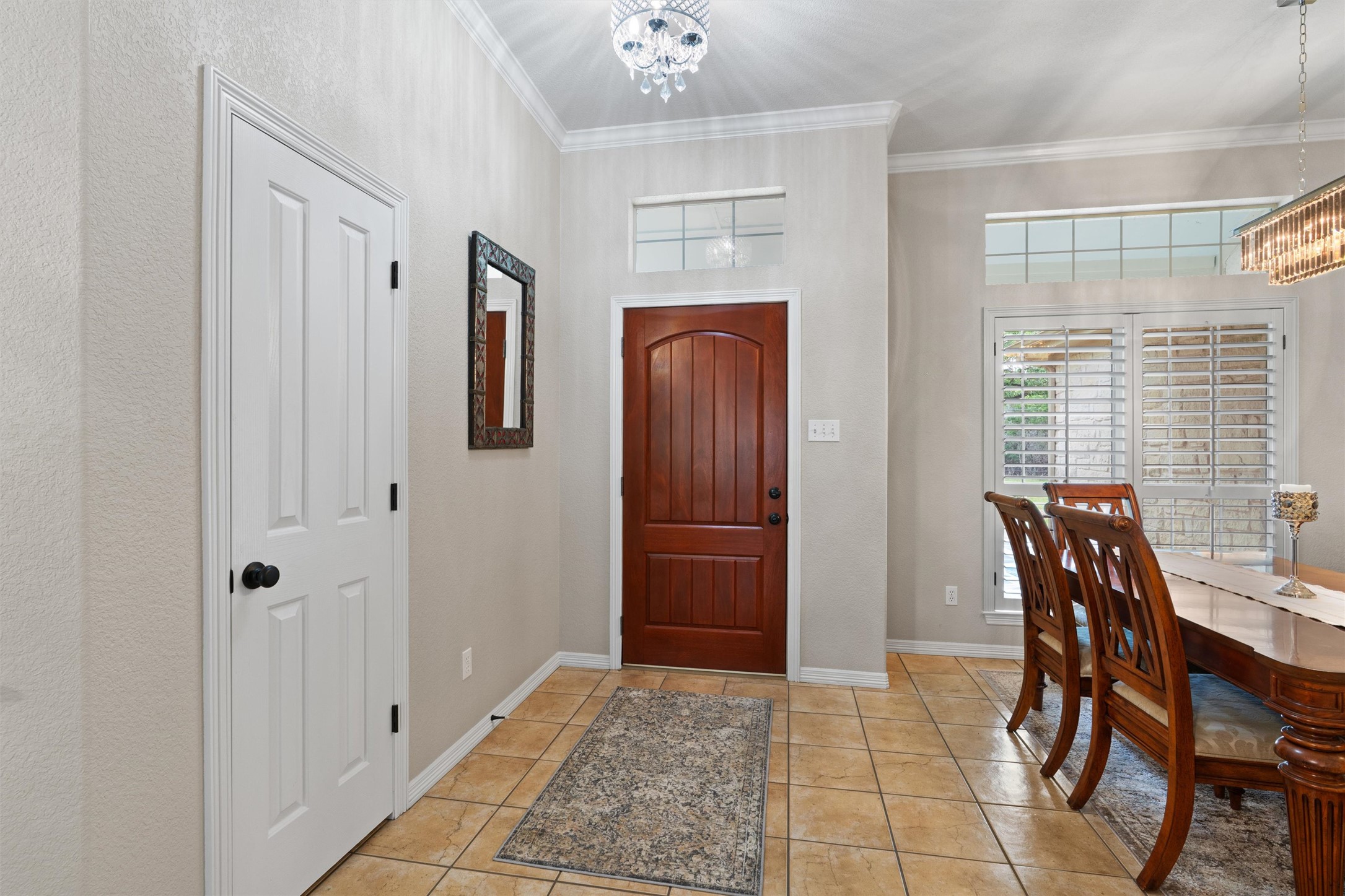 223 East Ridgewood Road Georgetown, TX 78633 - Photo 5 of 40 Welcoming entryway leading to a formal dining space with a beautiful chandelier