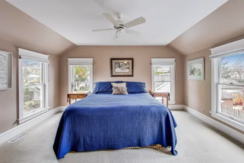 a bedroom with a large bed and a large window