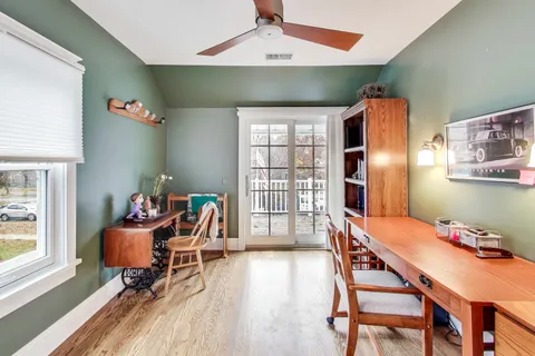 a dining room with furniture and wooden floor