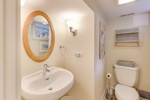 a bathroom with a toilet sink and mirror