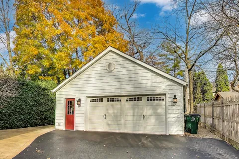 a view of a wooden house with a large trees