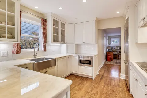 a kitchen with stainless steel appliances kitchen island granite countertop a stove and a sink