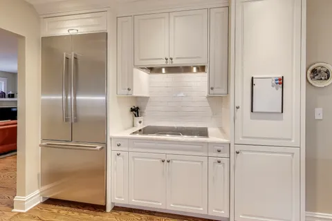 a kitchen with cabinets and a refrigerator