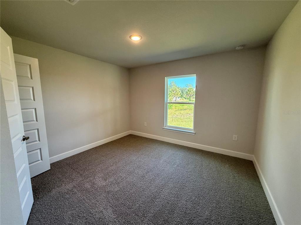 135 Hardee Way Rotonda West, FL 33947 - Photo 11 of 30 an empty room with windows