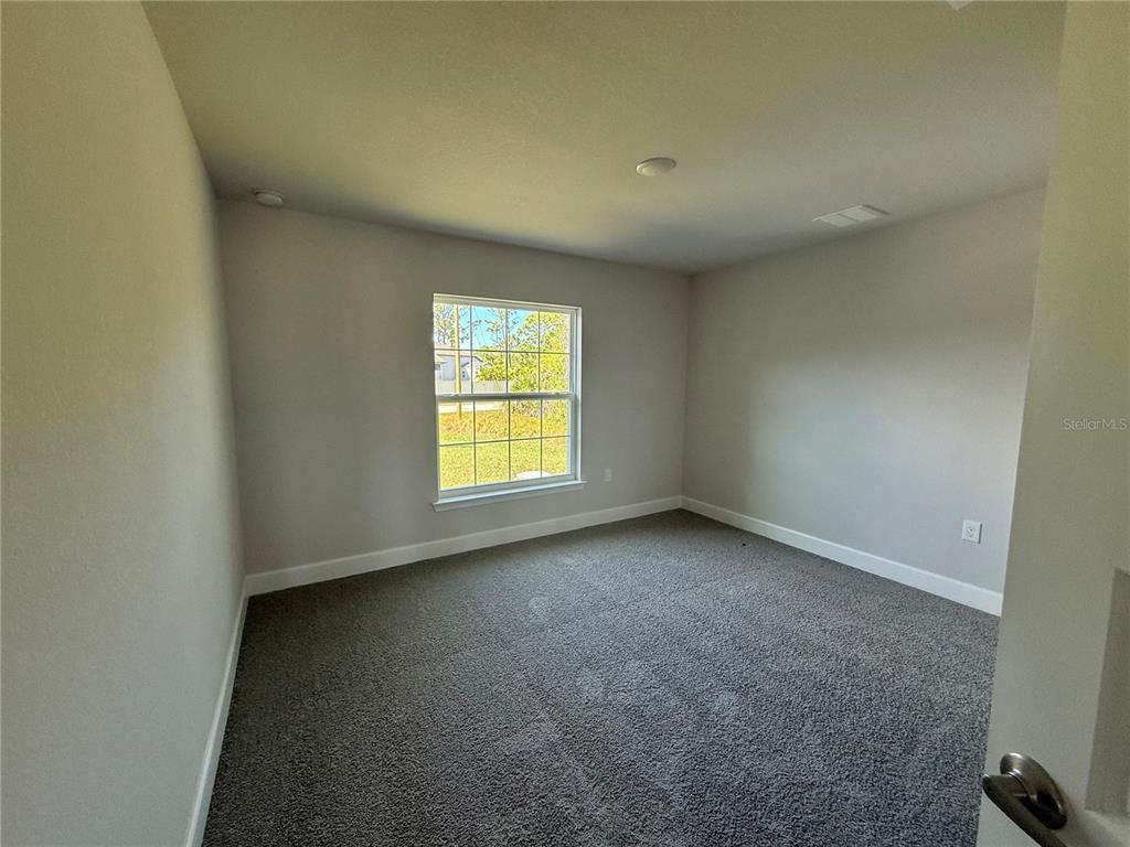 135 Hardee Way Rotonda West, FL 33947 - Photo 13 of 30 an empty room with a window