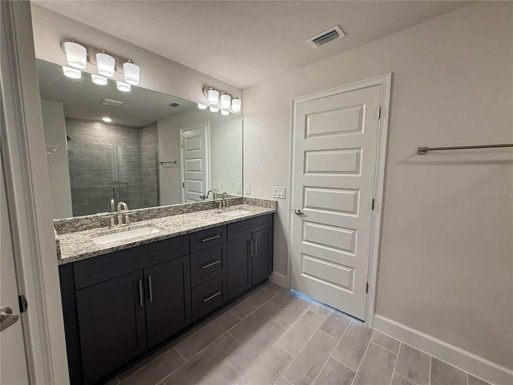 135 Hardee Way Rotonda West, FL 33947 - Photo 20 of 30 a bathroom with a granite countertop sink and a mirror