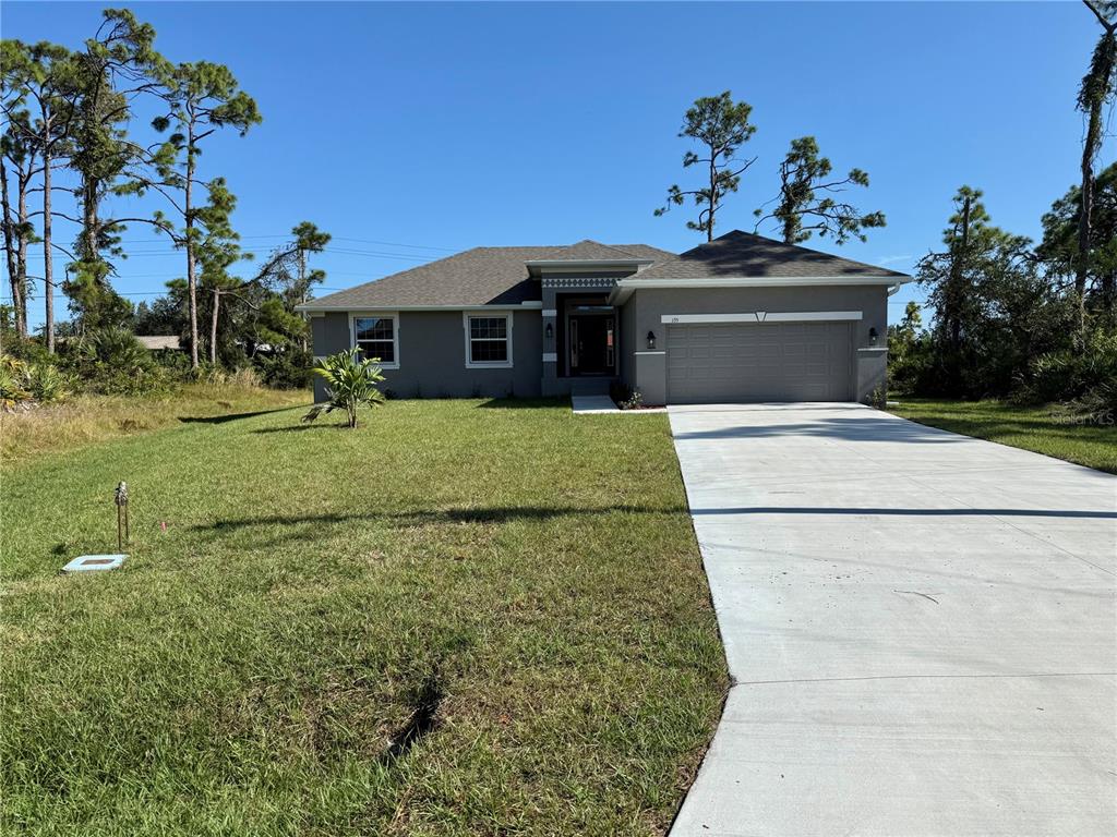 135 Hardee Way Rotonda West, FL 33947 - Photo 2 of 30 a front view of a house with a yard
