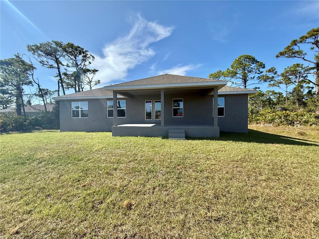 135 Hardee Way Rotonda West, FL 33947 - Photo 24 of 30 a front view of a house with a garden