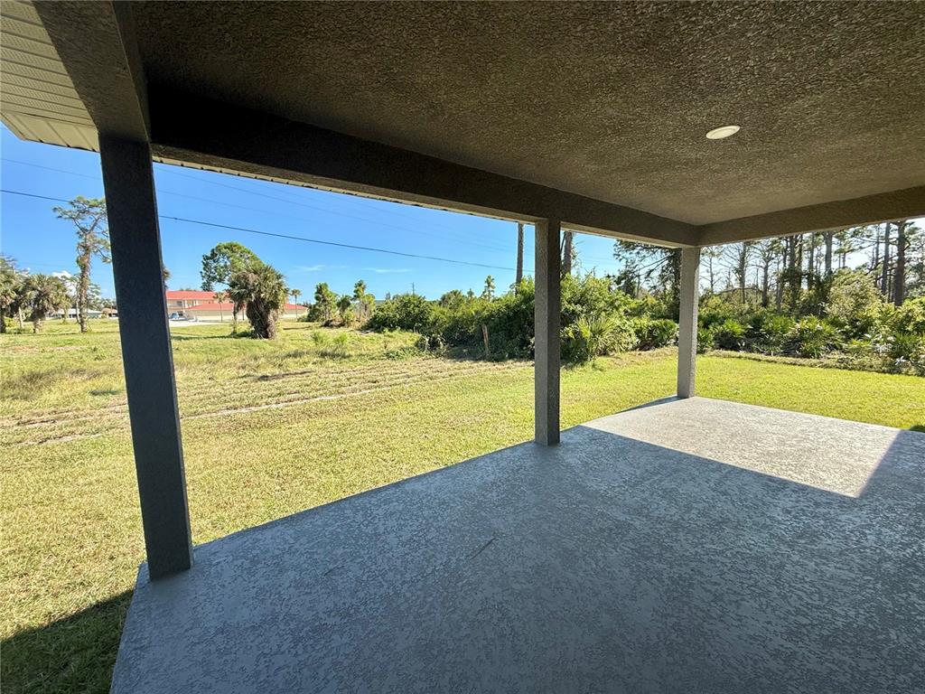 135 Hardee Way Rotonda West, FL 33947 - Photo 26 of 30 a view of an empty room with a floor to ceiling window and an outdoor space
