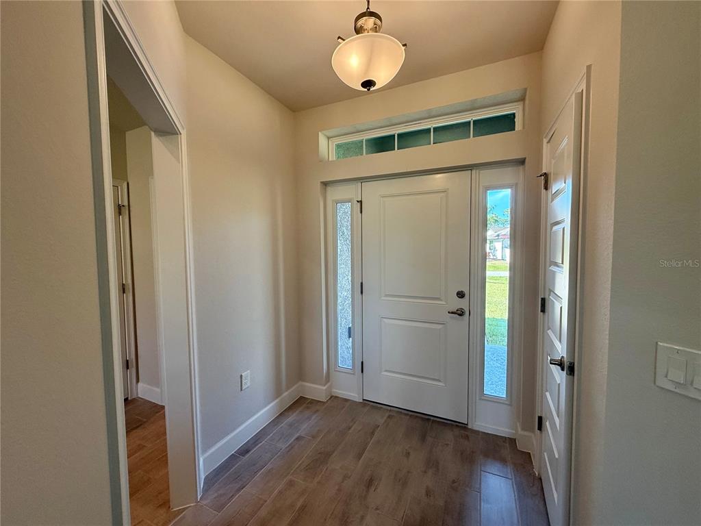 135 Hardee Way Rotonda West, FL 33947 - Photo 5 of 30 a view of a hallway with wooden floor