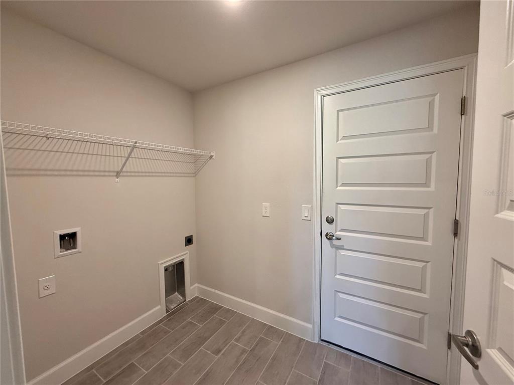 135 Hardee Way Rotonda West, FL 33947 - Photo 10 of 30 a view of walk in closet with empty racks
