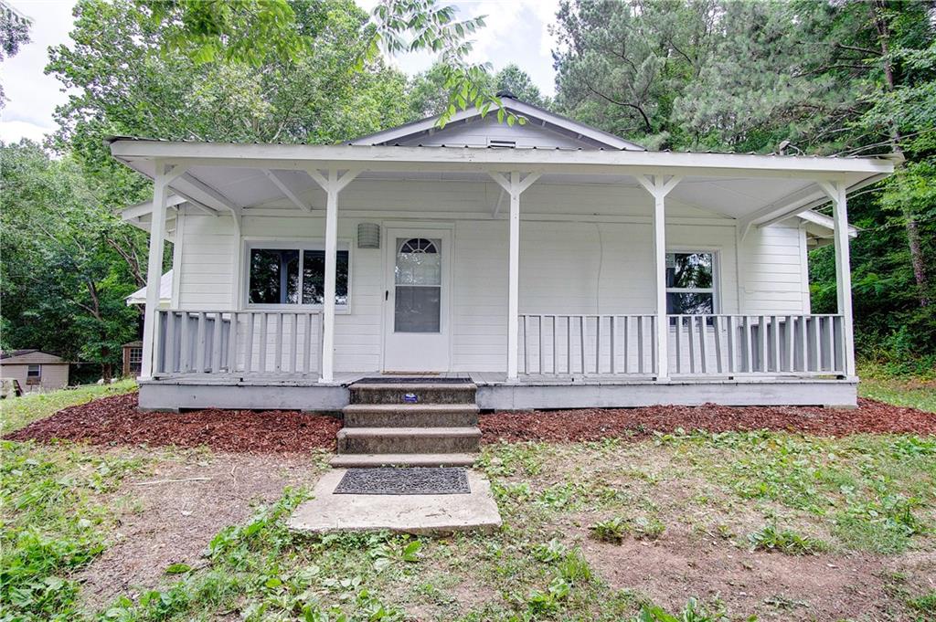 1039 School House Road Northeast Calhoun, GA 30701 - Photo 1 of 1 a front view of a house with garden