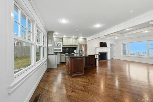 a large kitchen with stainless steel appliances granite countertop a large counter top and a stove