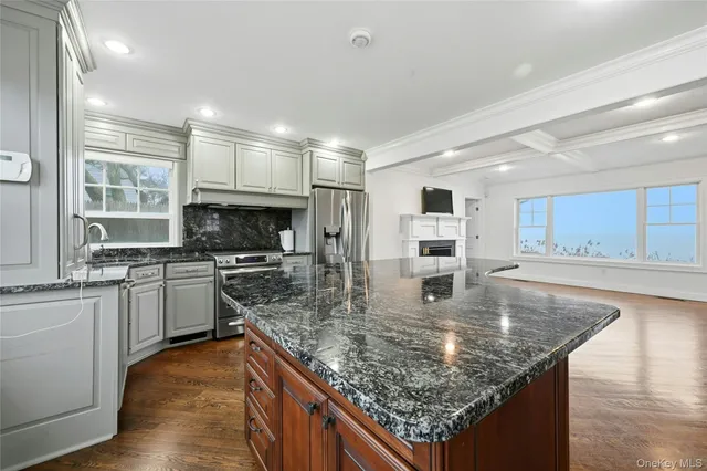 a kitchen with stainless steel appliances granite countertop a sink stove and refrigerator