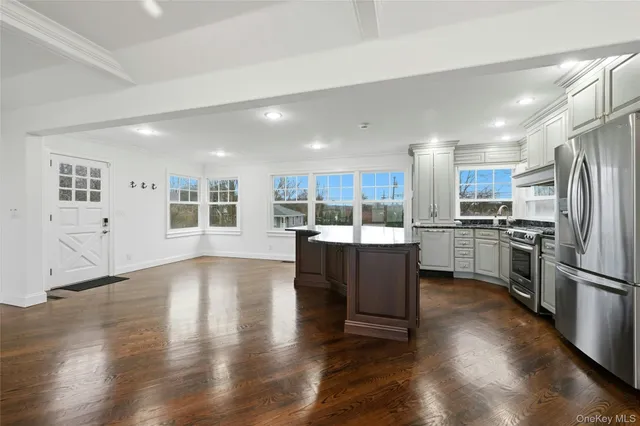 a kitchen with a refrigerator and a stove top oven