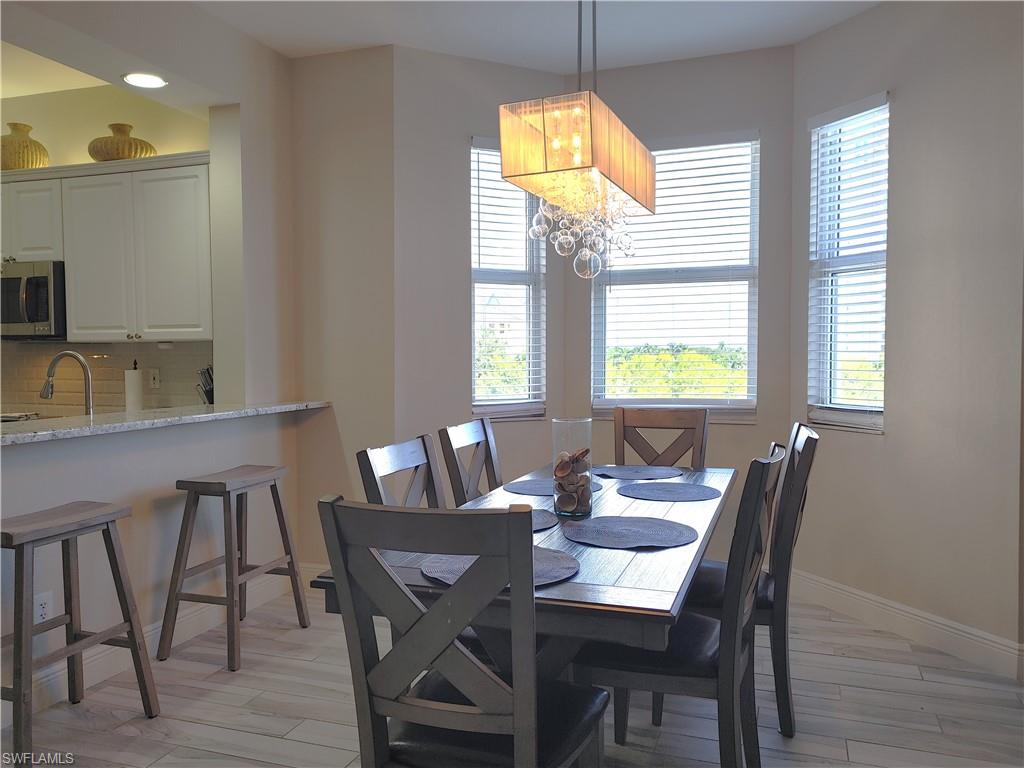 400 Flagship Drive, Unit 501 Naples, FL 34108 - Photo 12 of 38 a view of a dining room with furniture and window