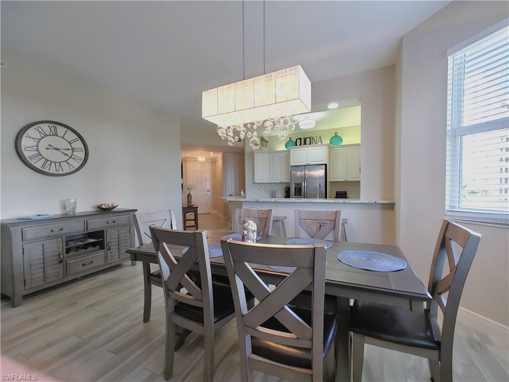 400 Flagship Drive, Unit 501 Naples, FL 34108 - Photo 13 of 38 a view of a dining room with furniture window and wooden floor