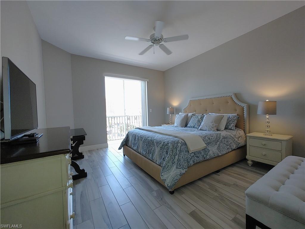 400 Flagship Drive, Unit 501 Naples, FL 34108 - Photo 17 of 38 a bedroom with a bed and a flat screen tv