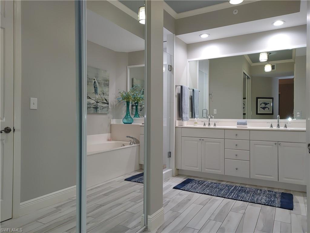 400 Flagship Drive, Unit 501 Naples, FL 34108 - Photo 19 of 38 a bathroom with a sink a toilet and shower
